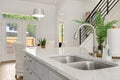 Beautiful brand new white stone kitchen island with a silver faucet and sinks