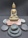 Beautiful brass Buddha statue sitting on a stone