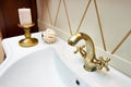 Beautiful brass faucet in retro and white sink