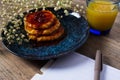 Beautiful Breakfast. Pancakes with jam and orange juice. Flowers and stylish dishes. A diary with blank pages. A healthy life