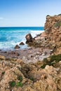 Beautiful breaking waves against rocks in turquoise water on atlantic ocean background Royalty Free Stock Photo