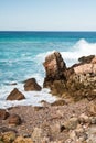 Beautiful breaking waves against rocks in turquoise water on atlantic ocean background Royalty Free Stock Photo