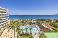 Beautiful breathtaking view from balcony of hotel overlooking hotel grounds and beach in Mediterranean sea. Royalty Free Stock Photo