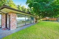 Beautiful brick house with glass walls. Backyard view