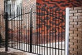 Beautiful brick and Metal Fence with Door and Gate of Modern Style Design Metal Fence Ideas Royalty Free Stock Photo