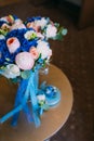 Beautiful bridal bouquet with creamy roses and peonies and blue hydrangeas. Wedding morning. Close-up Royalty Free Stock Photo