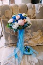 Beautiful bridal bouquet with creamy roses and peonies and blue hydrangeas. Wedding morning. Close-up Royalty Free Stock Photo