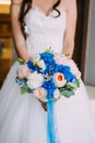 Beautiful bridal bouquet with creamy roses and peonies and blue hydrangeas. Wedding morning. Close-up Royalty Free Stock Photo