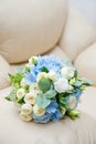 A beautiful bridal bouquet of delicate roses and other fresh flowers