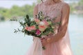 Beautiful bridal bouquet in hands of the bride. Wedding bouquet of peach roses by David Austin, single-head pink rose aqua, eucal Royalty Free Stock Photo