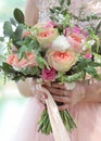 Beautiful bridal bouquet in hands of the bride. Wedding bouquet of peach roses by David Austin, single-head pink rose aqua, Royalty Free Stock Photo