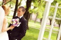 Beautiful bridal couple having fun in the park on their wedding day flower bouquet Royalty Free Stock Photo