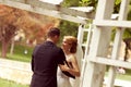 Beautiful bridal couple having fun in the park on their wedding day flower bouquet Royalty Free Stock Photo