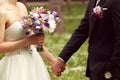 Beautiful bridal couple having fun in the park on their wedding day flower bouquet Royalty Free Stock Photo