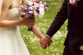 Beautiful bridal couple having fun in the park on their wedding day flower bouquet Royalty Free Stock Photo