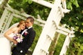 Beautiful bridal couple having fun in the park on their wedding day flower bouquet Royalty Free Stock Photo