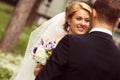 Beautiful bridal couple having fun in the park on their wedding day flower bouquet Royalty Free Stock Photo