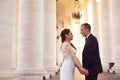 Beautiful bridal couple holding hands near columns Royalty Free Stock Photo