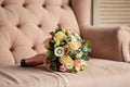 Beautiful bridal wedding bouquet lying on the armchair