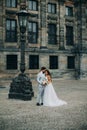 Beautiful bride and groom embracing and kissing on their wedding day outdoors Royalty Free Stock Photo