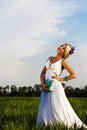 Beautiful bride blond blue eyes green field Royalty Free Stock Photo