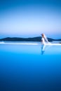 Beautiful bride blonde female model in amazing wedding dress poses on the island of Santorini