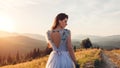 Beautiful bride in blue wedding dress with embroidery and bare back walking in mountains at sunset. Royalty Free Stock Photo