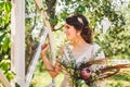 Beautiful bride with bouquet flowers stands on forest background. Rustic style. beautiful bride in delicate dress outdoors. Close Royalty Free Stock Photo