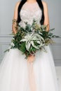 Beautiful bride with a bouquet of green branches