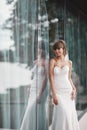 Beautiful bride in bridal gown with bouquet and lace veil on the nature. girl in a white wedding dress. Female portrait Royalty Free Stock Photo