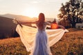 Beautiful bride dancing in blue wedding dress in mountains at sunset. Woman enjoys landscape holding gown Royalty Free Stock Photo