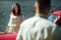 Beautiful bride and elegant stylish groom posing near retro car with tender feelings, concept of love and life Royalty Free Stock Photo