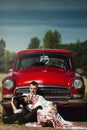 Beautiful bride and elegant stylish groom sitting near retro car with tender feelings, concept of love and life Royalty Free Stock Photo