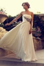 Beautiful bride in elegant wedding dress posing at summer park Royalty Free Stock Photo