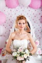 Beautiful bride with fashion wedding hairstyle and wedding dress posing in studio Royalty Free Stock Photo