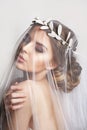 Beautiful bride with fashion wedding hairstyle - on white background.Closeup portrait of young gorgeous bride. Royalty Free Stock Photo