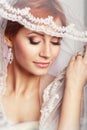 Beautiful bride with fashion wedding hairstyle - on white background.Closeup portrait of young gorgeous bride. Wedding. Studio Royalty Free Stock Photo