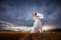 Beautiful bride in forest,cloudy twilight blue sky