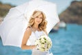 Beautiful bride girl in wedding dress with white umbrella and bo Royalty Free Stock Photo