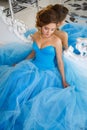 Beautiful bride in gorgeous blue dress Cinderella style near mirror Royalty Free Stock Photo