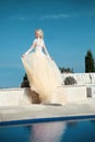 Beautiful bride in gorgeous wedding dress with blowing skirt Royalty Free Stock Photo