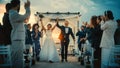 Beautiful Bride and Groom Celebrate Wedding Outdoors on a Beach Near the Ocean at Sunset. Perfect Royalty Free Stock Photo