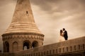 Beautiful bride and groom embracing and kissing on their wedding day in old city Royalty Free Stock Photo