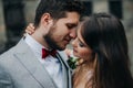 Beautiful bride and groom embracing and kissing on their wedding day outdoors Royalty Free Stock Photo