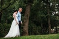 Beautiful bride and groom hugging and kissing on their wedding day outdoors. Concept wedding, new family. Royalty Free Stock Photo