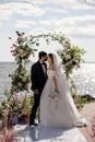 Beautiful Bride and Groom During an Outdoors Wedding Ceremony on a Beach Near the Sea. Perfect Venue Royalty Free Stock Photo