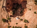 Aerial drone photo - Bride and groom overlooking a sinkhole in the Utah desert. Royalty Free Stock Photo