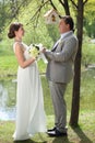 Beautiful bride and groom standing in a park Royalty Free Stock Photo