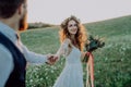 Beautiful bride and groom at sunset in green nature. Royalty Free Stock Photo