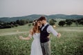 Beautiful bride and groom at sunset in green nature. Royalty Free Stock Photo